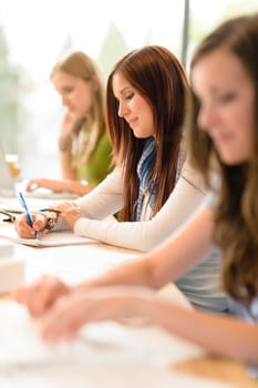 Student teenager studying at classroom sitting in a row