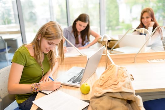 Students group working on computer at study room high school