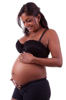 Young beautiful pregnant indian touching her tummy, isolated on white background