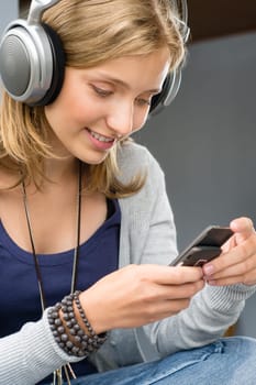 Woman checking her mobile phone young happy looking message