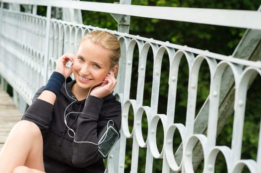 Listening to music headphones young woman resting sport smiling happy