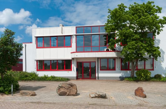 modern white office building with red windows