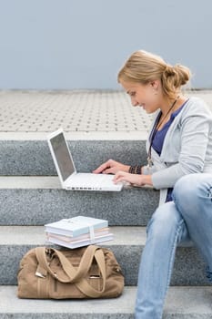 Student woman sitting on steps work laptop computer