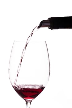 Bordeaux red wine poured from a wine bottle