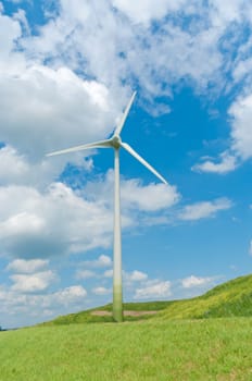 wind turbine on a green hill