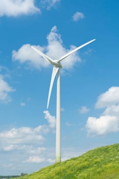 wind turbine on a green hill