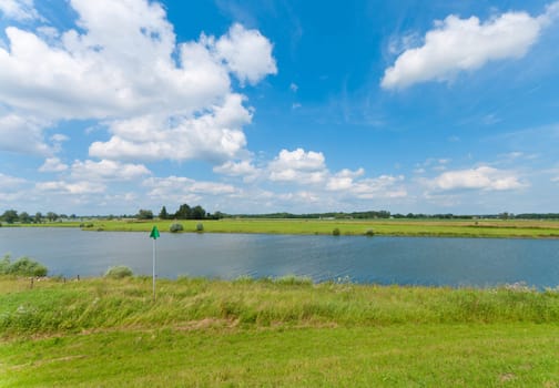 view of a dutch canal under a nice sky