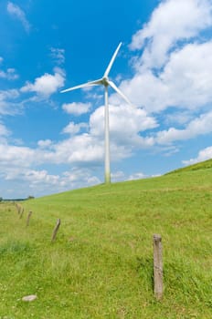wind turbine on a green hill