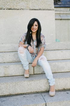 Beautiful girl sitting on stairs