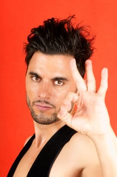 Attractive 30 years old man making ok gesture over an orange background