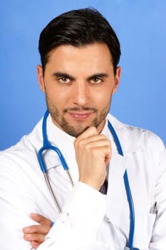 Handsome doctor with stethoscope. Over a blue background.