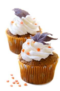 Pumpkin spice cupcakes with cream cheese frosting decorated with chocolate leaves