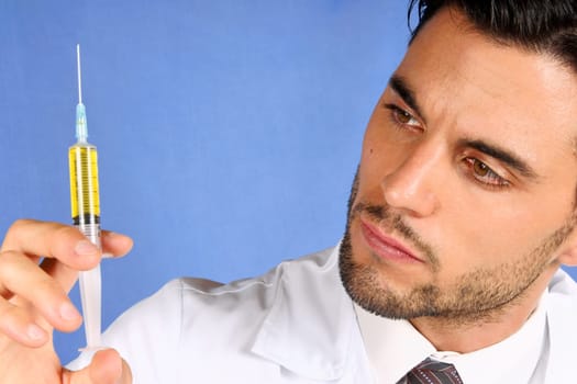 Mid adult doctor holding a syringe with yellow medicine. With copy space
