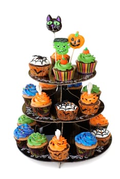 Three tier cupcake stand with lollipops on the top