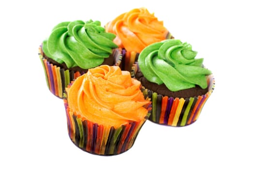 Chocolate cupcakes with vanilla frosting colored in bright colors.