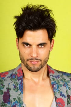 Portrait of a trendy 30 years old man with beard over a light green background