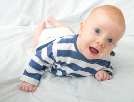 Closeup of Happy Smiling Newborn Baby Lying on Front