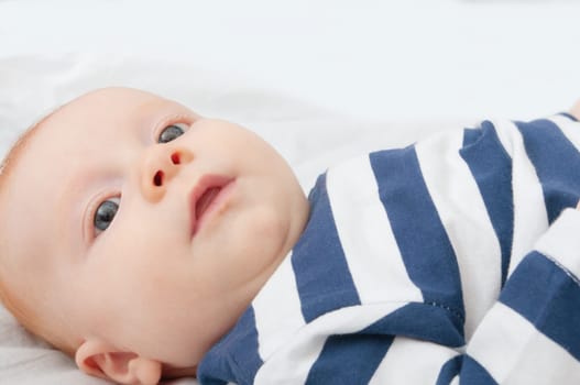Closeup of Happy Smiling Newborn Baby Lying on Back