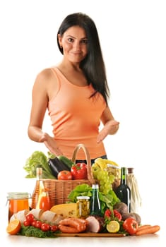 Young woman with variety of grocery products including vegetable, fruits, meat, dairy and wine