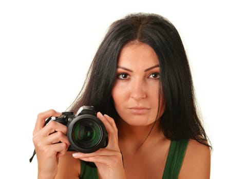Young woman holding camera isolated on white. Taking pictures.
