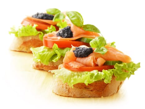 Three sandwiches with salmon and caviar. Fish snack