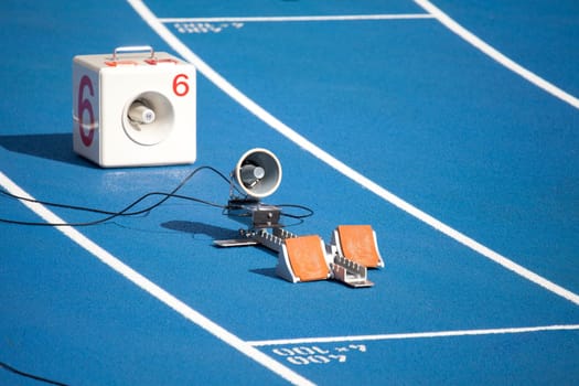 Start block of sprinters and loudspeaker