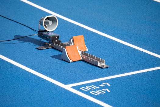 Start block of sprinters and loudspeaker