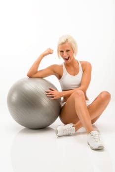 Cheerful woman posing with fitness ball isolated white background