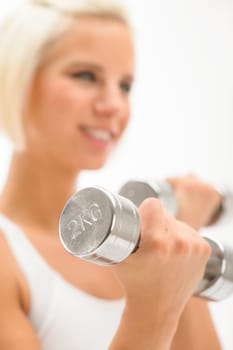 Sportive blond woman exercise biceps with weights isolated on white