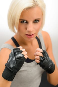 Rough woman ready to fight with boxing bandage gloves