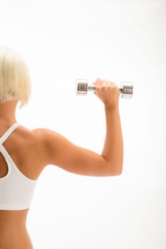 Back view portrait muscular blond woman holding dumbbell on white