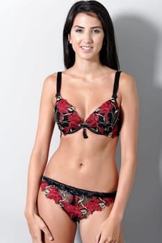 Beautiful young woman in sexy red underwear smiling