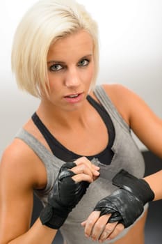 Kick-box woman wear protective gloves prepare for fitness workout