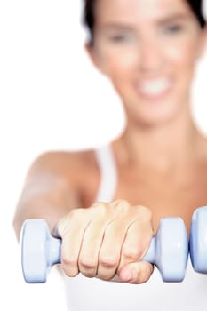 Beautiful young woman training with weights at home