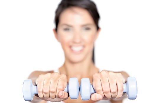 Beautiful young woman training with weights at home
