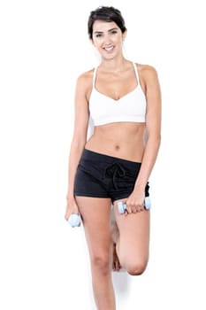 Beautiful young woman training with weights at home