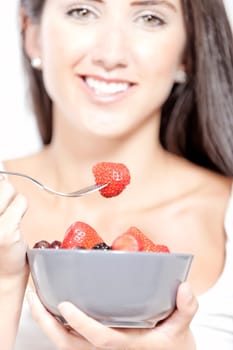 Beautiful young woman enjoying fresh fruit for breakfast at home