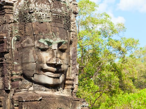 Massive stone faces decorating towers of Bayon temple in Angkor Thom, Cambodia