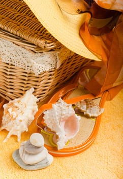 Beach items a hat, a towel and slippers, a close up conceptual image of summertime vacation