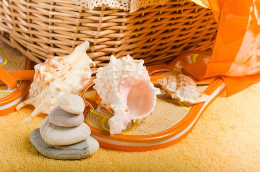 Beach items a hat, a towel and slippers, a close up conceptual image of summertime vacation