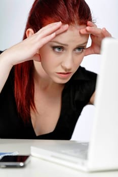 Professional woman showing concern at work using her laptop