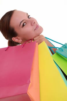 Young woman with colorful shopping bags isolated