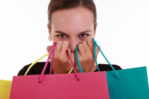 Young woman with colorful shopping bags isolated