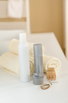 Close-up of hair products and towels in bathroom