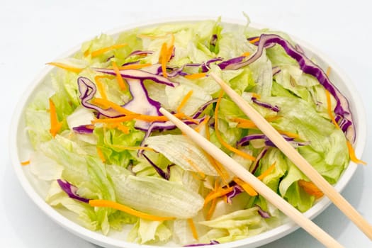 mixed salad presented in plate. Lettuce beet and carrot freshly cut.