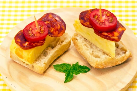 Spanish omelette with chorizo Iberico, typical cover montadito