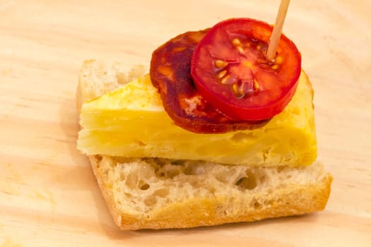 Spanish omelette with chorizo Iberico, typical cover montadito