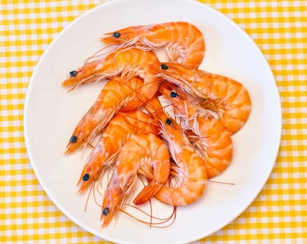 Pile of cooked and peeled shrimp. Presented in plate