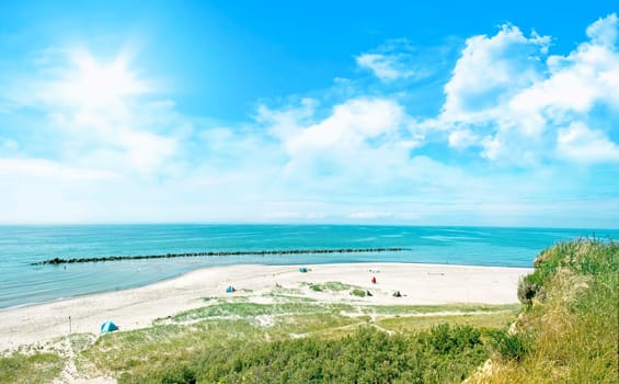natural ocean beach panorama with cloudy sky