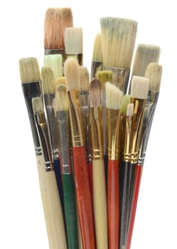 Artists brushes against a white background